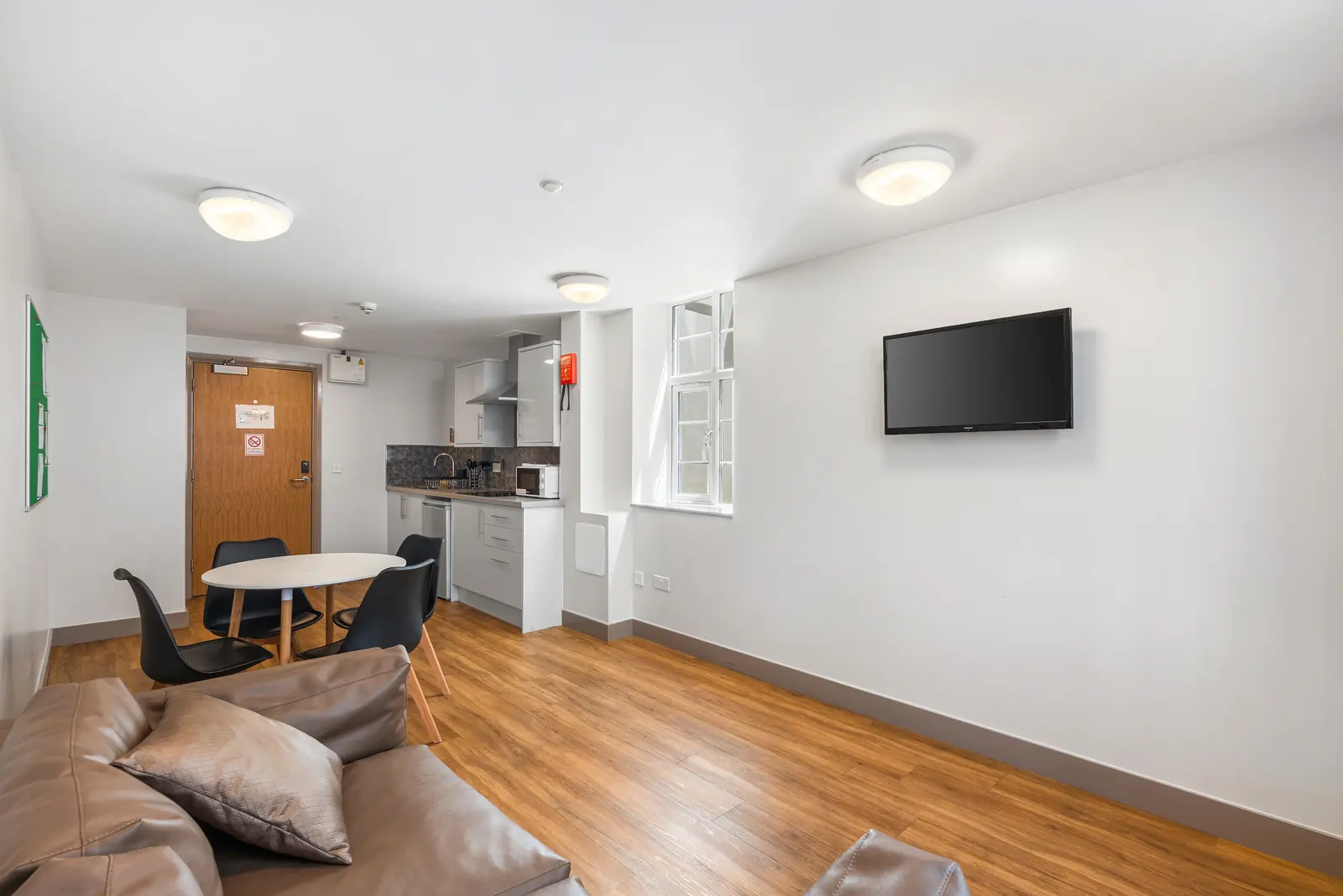 Shared lounge with sofas and dining table